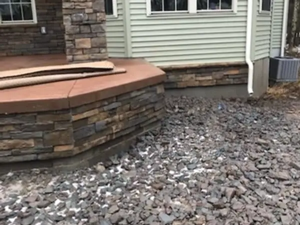 Curved stone veneer face and stone column on the finished deck