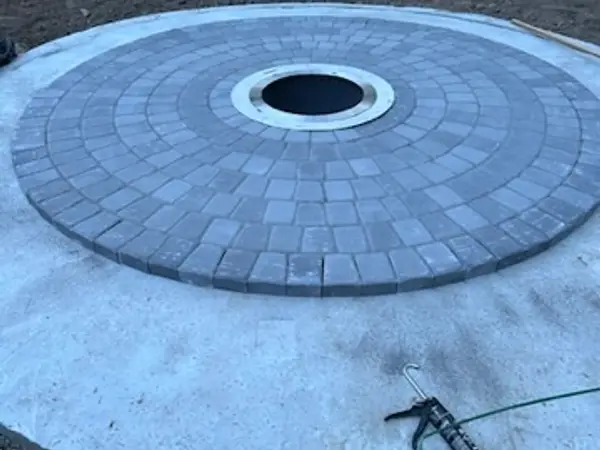 Circular paver pad surrounding the sunken fire pit insert