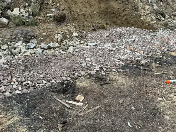 Excavated and leveled stone base for the retaining wall