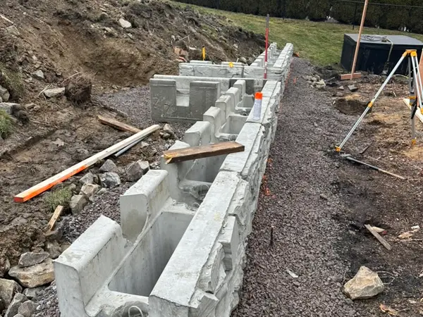 Base course of Magnum Stone blocks running along the excavated slope