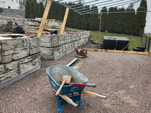 Gravel base inside the lower wall, ready for the concrete slab