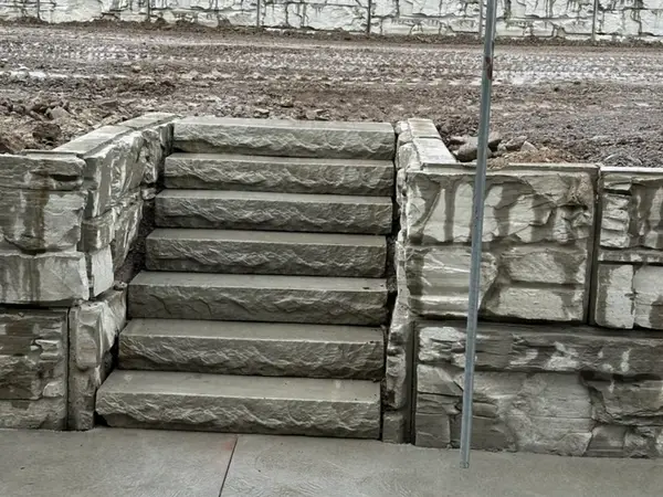 Stone steps leading from the slab up to the upper terrace