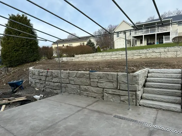 Wide view of the finished two tier wall, steps, and slab